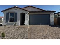 Inviting single-story home featuring a two-car garage, covered entry, and low-maintenance landscaping at 39967 W Anne Ln, Maricopa, AZ 85138