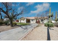 Charming single-story home with a winding driveway and desert landscaping at 8310 W Daley Ln, Peoria, AZ 85383