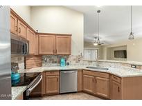 Modern kitchen with stainless steel appliances, granite countertops, and stylish cabinetry at 16336 N 168Th Ave, Surprise, AZ 85388