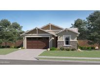 Charming single-story home featuring stone accents, a two-car garage, and a well-maintained lawn at 16708 W Chama Dr, Surprise, AZ 85387