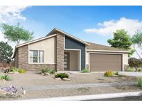 Charming single-story home with a mix of stucco, stone, and siding, plus a desert landscape at 18510 W Tohono Dr, Goodyear, AZ 85338