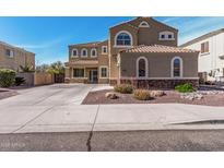 Stunning two-story home with well-manicured desert landscaping and a spacious driveway at 21216 N 96Th Ave, Peoria, AZ 85382