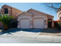 Charming home features a two-car garage, desert landscaping, and a neutral color palette at 3547 W Whispering Wind Dr, Glendale, AZ 85310