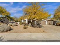 Charming single-story home featuring a low-maintenance yard and a spacious three-car garage at 6448 E Hearn Rd, Scottsdale, AZ 85254