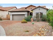 Charming home featuring stone accents, desert landscaping, and a brick-paved driveway at 6959 E Red Hawk Cir, Mesa, AZ 85207