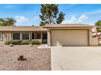 Charming single-story home featuring a two-car garage and desert landscaping at 11616 S Jokake St, Phoenix, AZ 85044