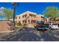 Condominium complex with awnings, ample parking and desert landscaping, creating a welcoming curb appeal at 16657 E Gunsight Dr # 296, Fountain Hills, AZ 85268