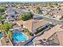 Aerial view of a home with a pool, covered patio, and lush landscaping in a well-manicured neighborhood at 2091 E Flintlock Way, Chandler, AZ 85286