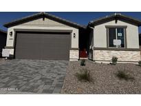 Charming single-story home featuring stone accents, neutral stucco, and a well-maintained front yard at 21555 N Rummler Ln, Maricopa, AZ 85138