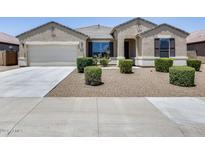 Charming single-story home featuring a neutral color scheme, well-manicured landscaping and a two-car garage at 26020 N 138Th Ln, Peoria, AZ 85383