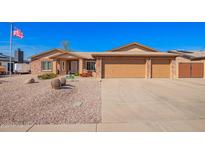 Charming brick home featuring a three-car garage, low maintenance front yard and an American flag in the front at 3408 W Taro Ln, Phoenix, AZ 85027