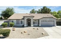 Charming single-story home with desert landscaping, tile roof, and an attached two-car garage at 3613 E Baranca Ct, Gilbert, AZ 85297