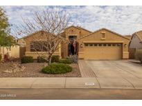 Charming single-story home with a well-maintained front yard, a two car garage, and desert landscaping at 3896 E Aragonite Ln, San Tan Valley, AZ 85143