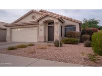 Charming single-story home featuring a two-car garage, desert landscaping, and a cozy front porch entrance at 4032 E Jojoba Rd, Phoenix, AZ 85044