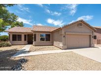 Charming single-story home showcasing desert landscaping and a well-maintained facade at 6450 S Windstream Pl, Chandler, AZ 85249
