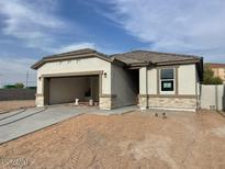 Charming single-story home featuring stone accents and an attached two-car garage, blending comfort and convenience at 1317 S Vista Ave, Florence, AZ 85132
