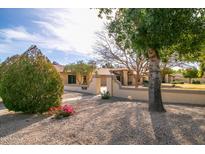 Charming home featuring desert landscaping, mature trees, and a walkway leading to the entrance at 13635 W Countryside Dr, Sun City West, AZ 85375