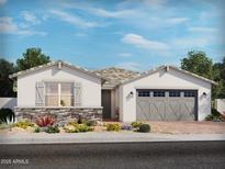 Charming single-story home with stone accents, neutral colors, and a well-manicured front yard at 17671 W Odeum Ln, Goodyear, AZ 85338