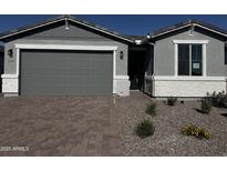 Charming single-story home featuring a gray color scheme, paver driveway, and low-maintenance desert landscaping at 21465 N Rummler Ln, Maricopa, AZ 85138