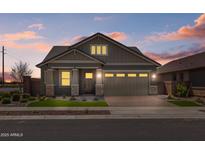Charming single-story home with well-maintained landscaping, stone accents, and a paved driveway at 23161 E Mockingbird Dr, Queen Creek, AZ 85142