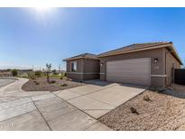 New construction home featuring a concrete driveway, two-car garage, and low maintenance desert landscaping at 31476 N Hayweather Ln, San Tan Valley, AZ 85143