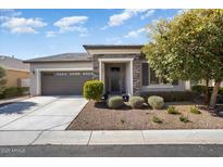 Charming home with a stone entryway, well-maintained landscaping, and a two-car garage at 4728 N 204Th Ln, Buckeye, AZ 85396