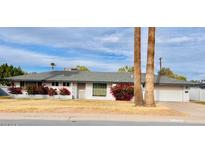 Charming single-story home featuring a well-manicured lawn and mature trees at 5016 E Cheery Lynn Rd, Phoenix, AZ 85018