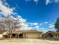 Charming single-story home with a well-maintained front yard, two car garage, and inviting curb appeal at 8611 W Village Dr, Peoria, AZ 85382