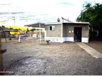 Exterior of a single story home, with desert landscaping at 9716 E Birchwood Ave, Mesa, AZ 85208