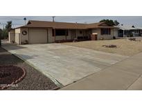 Charming single-story home with low-maintenance desert landscaping and spacious driveway at 12236 N Pebble Beach Dr, Sun City, AZ 85351