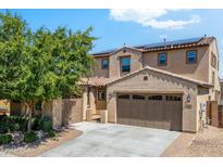 Charming two-story home with a two car garage, desert landscaping, and a cozy front porch at 16074 W Cortez St, Surprise, AZ 85379