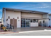 Exterior of home with tandem carport, additional storage and mature landscaping at 17200 W Bell Rd # 845, Surprise, AZ 85374