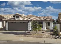 Charming single-story home with a tile roof and a well-maintained front yard at 1734 E Commonwealth Cir, Chandler, AZ 85225