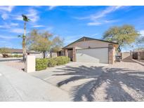 Charming single-story home with a desert landscape, palm tree, and a two-car garage at 19061 N 5Th Ave, Phoenix, AZ 85027