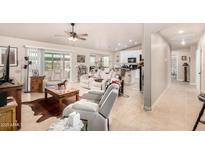 Spacious living room features a tile floor, comfortable seating, and open layout to kitchen and dining areas at 20438 W Carver Rd, Buckeye, AZ 85326