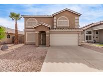 Charming two-story home with a two-car garage and desert landscaping at 2551 E Kent Ave, Gilbert, AZ 85296