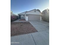 Charming single-story home featuring a two-car garage and desert landscaping at 2837 W Angela Dr, Phoenix, AZ 85053