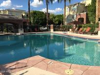 Resort-style community pool with lounge chairs and meticulously maintained landscaping at 3302 N 7Th St # 234, Phoenix, AZ 85014