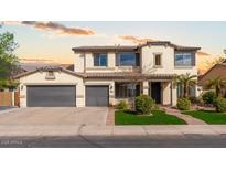 Charming two-story home featuring a well-manicured front yard, desert landscaping, and a three-car garage at 3416 E Blue Ridge Pl, Chandler, AZ 85249