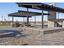 Outdoor kitchen includes seating, stainless steel grills, and a covered pergola at 37093 W La Paz St, Maricopa, AZ 85138