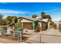 Charming single-story home with fenced yard and desert landscaping under a beautiful blue sky at 398 W Elgin St, Chandler, AZ 85225