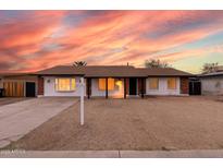 Charming single-story home featuring a well-maintained front yard and a classic ranch-style architecture at 4052 W Eva St, Phoenix, AZ 85051