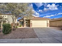 Inviting single-Gathering home with a two-car garage, desert landscaping, and a mature shade tree at 6709 S 49Th Dr, Laveen, AZ 85339