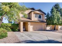 Inviting two-story home featuring a two-car garage and mature landscaping at 921 S Val Vista Dr # 59, Mesa, AZ 85204