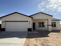 A bright, modern single-Gathering home with a white exterior, dark trim, and a two-car garage at 10281 W Concordia Dr, Arizona City, AZ 85123