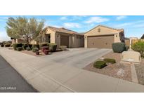 Charming home features a neutral stucco exterior, tile roof, manicured bushes, and a concrete driveway leading to a two-car garage at 10778 W Whitehorn Way, Peoria, AZ 85383