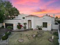 Beautiful single-story home with desert landscaping and a unique architectural design at sunset at 1157 N Date Palm Dr, Gilbert, AZ 85234