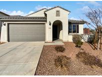 Charming single-story home with a well-manicured front yard and a two-car garage at 16416 W Cottontail Ln, Surprise, AZ 85387