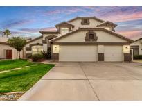 Charming two-story home featuring a three-car garage and well-maintained front yard at 1865 E Pinto Dr, Gilbert, AZ 85296