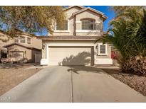 Charming two-story home with a large driveway and desert landscaping at 21487 N Greenway Rd, Maricopa, AZ 85138